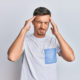 Handsome caucasian man wearing casual clothes with hand on head, headache because stress. suffering migraine.