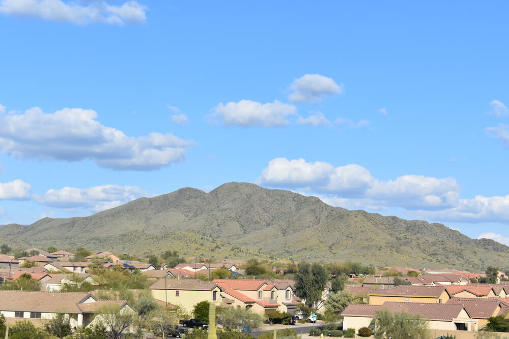 A beautiful shot of the Daisy Mountain landscape view with clouds and blue sky in Anthem, Arizona