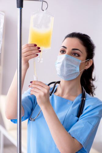 Young female nurse with banana bag