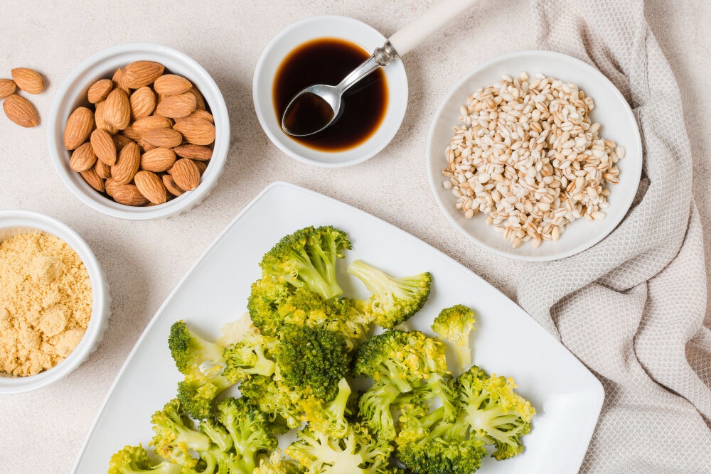 Almonds, barley, broccoli, and leafy greens arranged as nutrient-rich foods